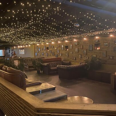 Bar interior with lounge seating and twinkling lights.