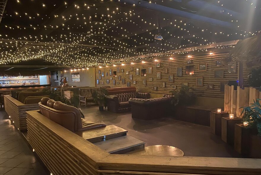 Bar interior with lounge seating and twinkling lights.