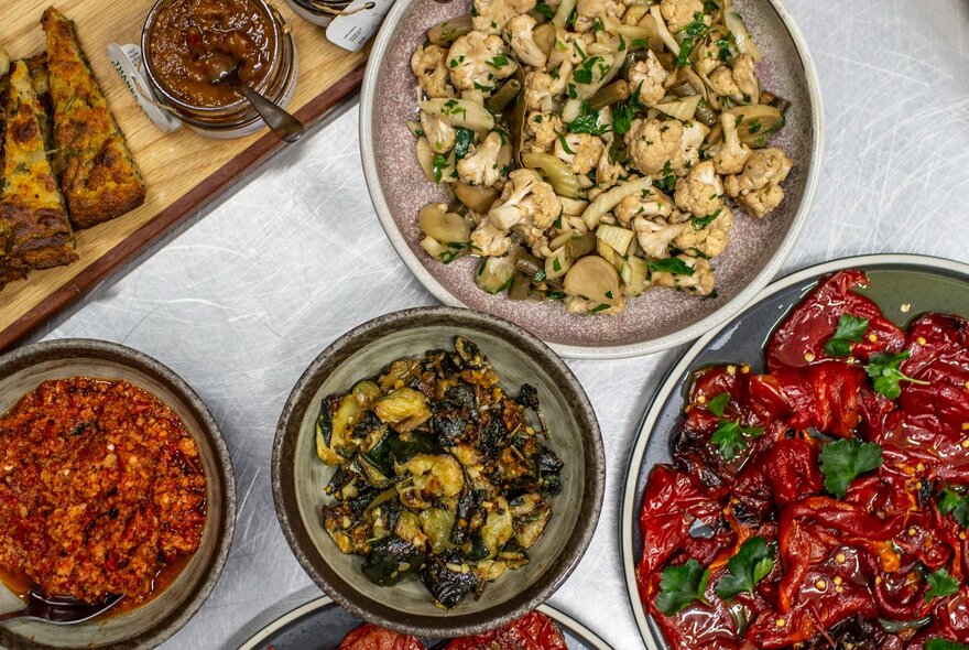Looking down at share-style platters of food on a table.