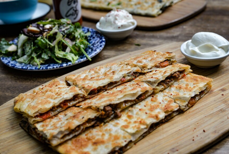 A plate of gözleme served with salad.