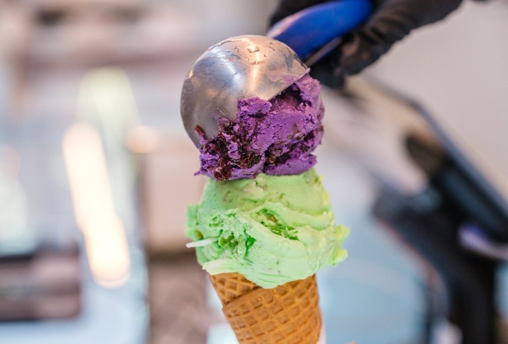 Two scoops of ice cream on a cone