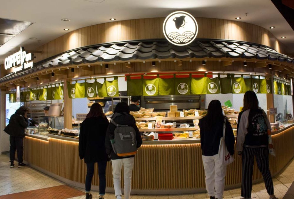 People ordering at a bakery