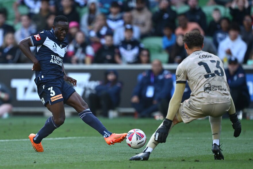 Soccer players kicking the ball during a match.