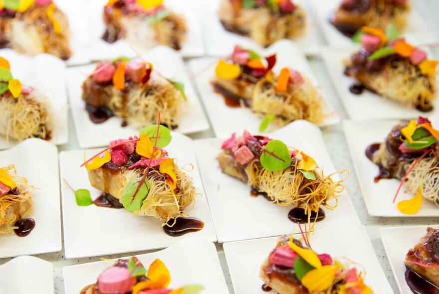 Rows of identical coconut and fruit desserts.