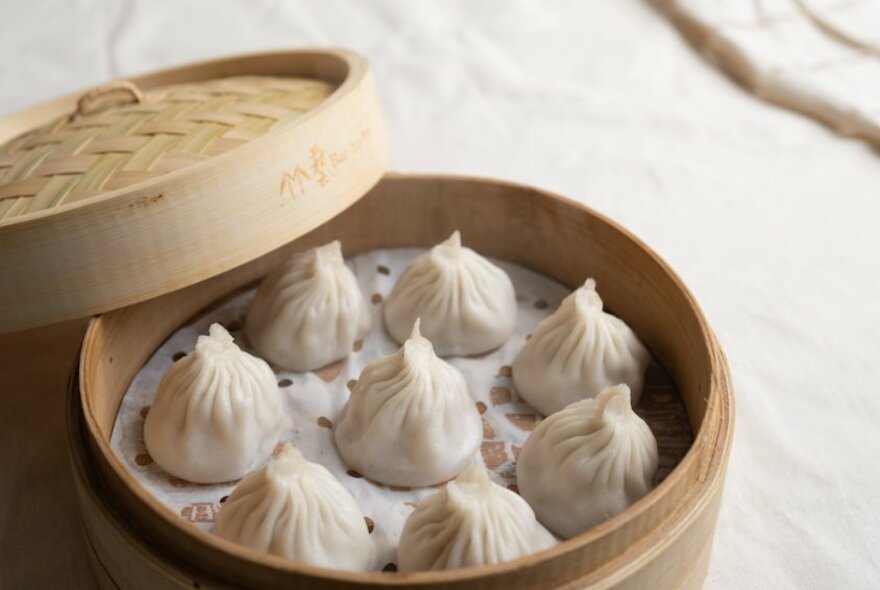 Chinese dumplings in a bamboo container.