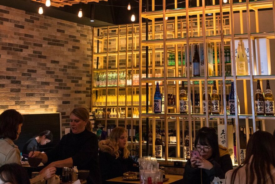 People dining in a dimly-lit restaurant.