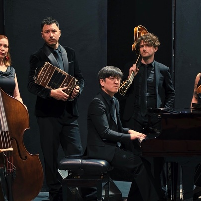 Five-piece musical ensemble with bass, piano and stringed instruments.
