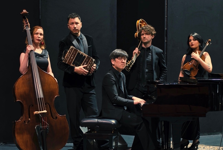 Five-piece musical ensemble with bass, piano and stringed instruments.