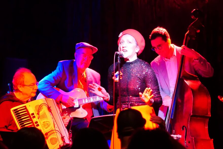 Acclaimed French chanteuse, Noria Letts, on stage with a three-piece band comprising the acccordian, guitar and double bass.