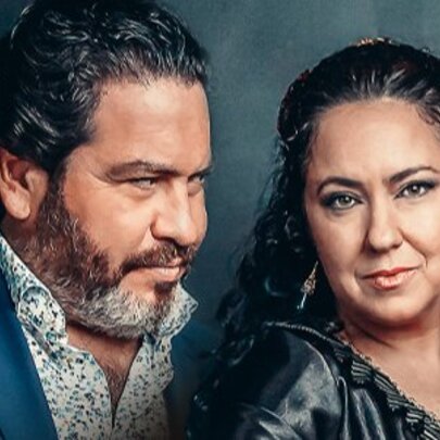 Musician Paco Lara looking at and Spanish dancer Deya Miranda as she stares ahead. 