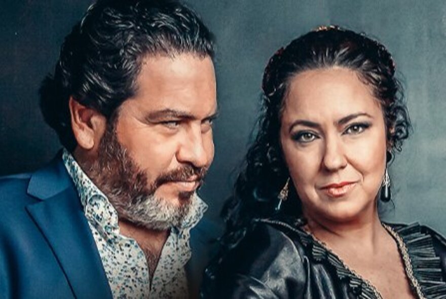 Musician Paco Lara looking at and Spanish dancer Deya Miranda as she stares ahead. 