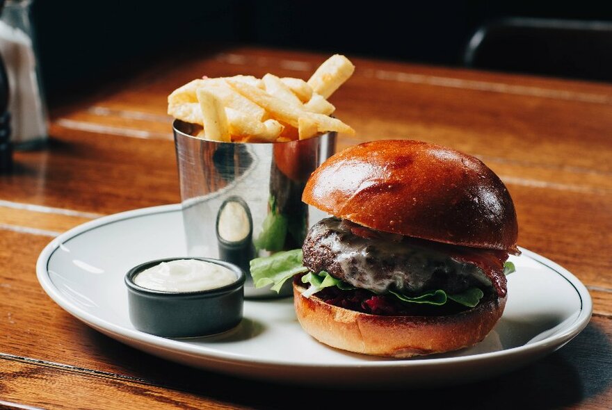 A hamburget and chips with aioli.