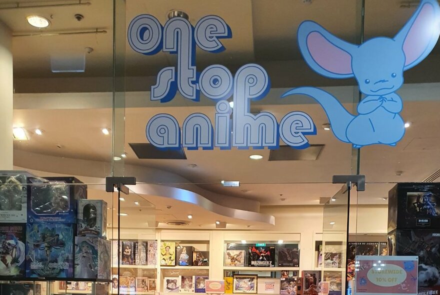 Store signage and ceiling with products displayed on shelves.