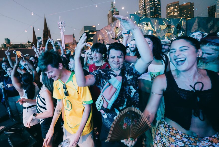 Revellers enjoying an open air dance party at Melbourne's Fed Square.