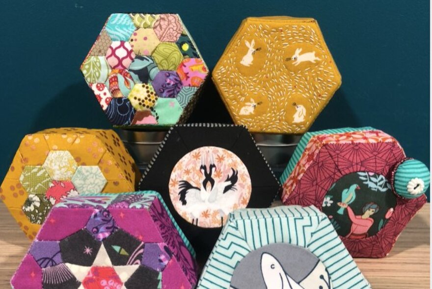 A selection of hand crafted 3D trinket boxes using English paper piecing quilting techniques.