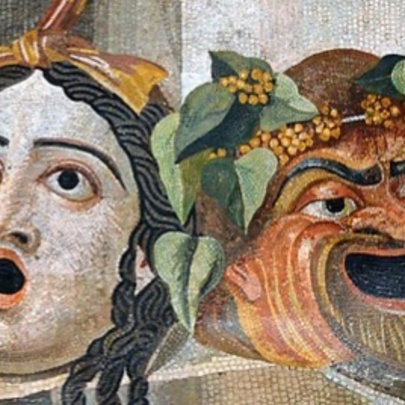 Ancient Roman wall mosaic of two theatrical masks depicting the faces of comedy and tragedy.