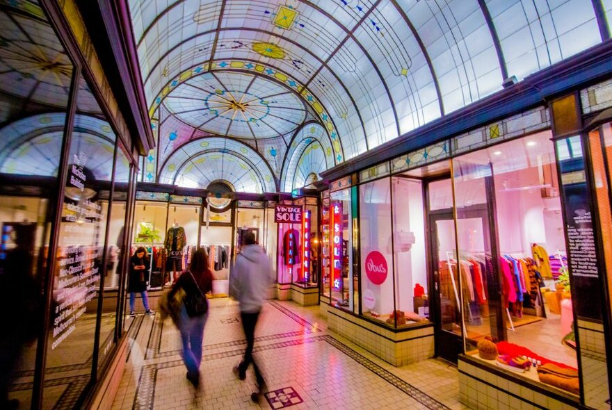 Interior of the Cathedral Arcade, showing the glass ceiling and glass-fronted shops.