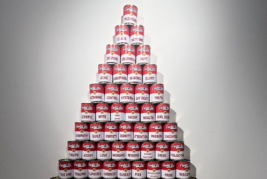 Warhol-inspired artwork red and white cans in a pyramid display.