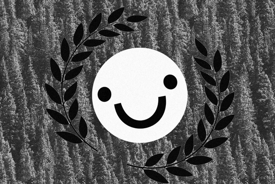 Smile button surrounded by laurel leaf wreath.