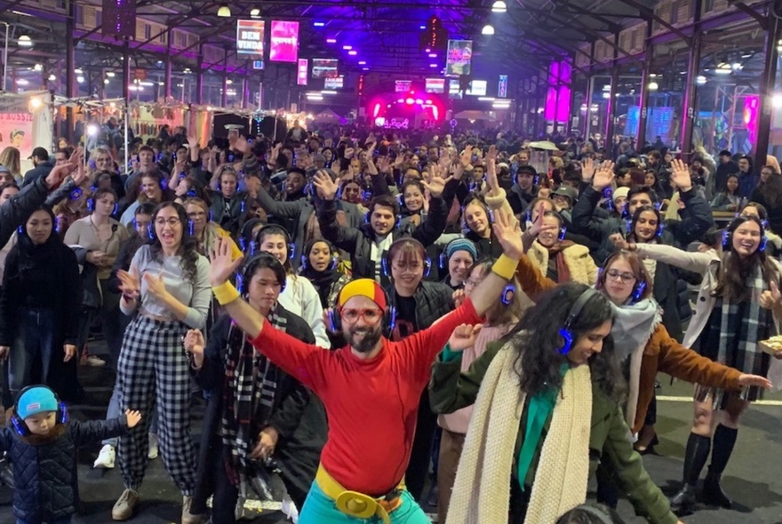 A large group of people dancing at Queen Victoria Market.
