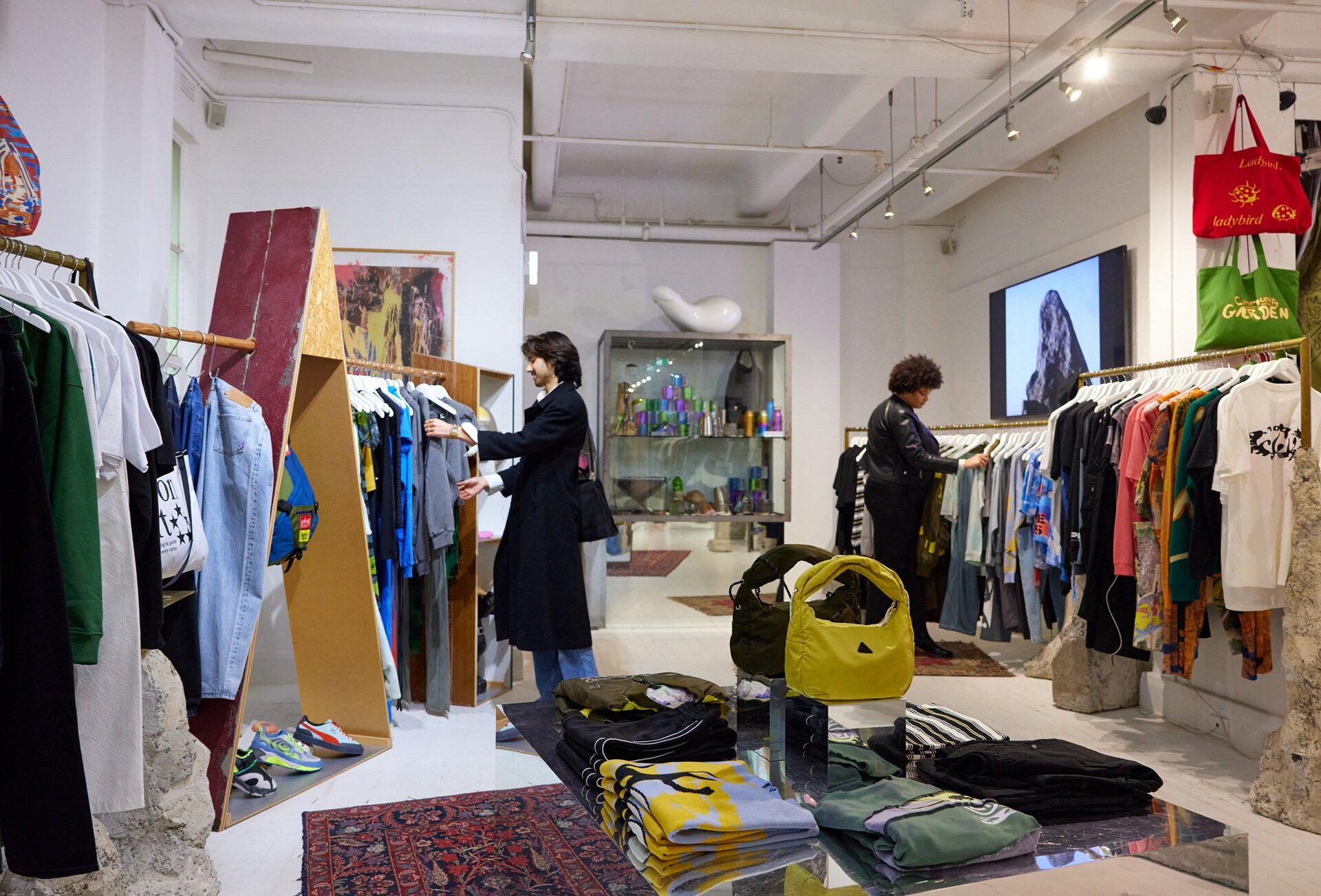 Two friends are browsing clothes in a clothing store.