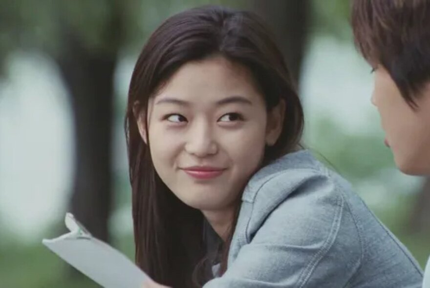 A Korean woman in a light denim jacket, smiling.