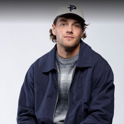Collingwood AFL football player Patrick Lipinski, wearing a cap and casual jacket.