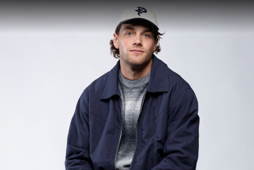 Collingwood AFL football player Patrick Lipinski, wearing a cap and casual jacket.