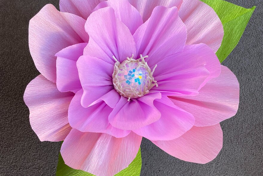 An oversized hand made paper flower.