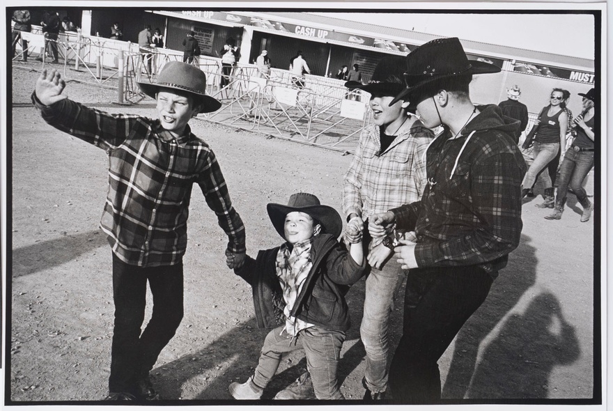 Vintage photograph of boys wearing cowboy hats and plaid shirts.