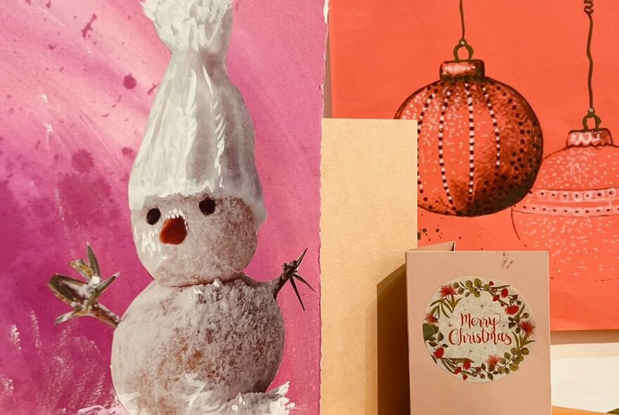 Christmas cards featuring a snowman and baubles.