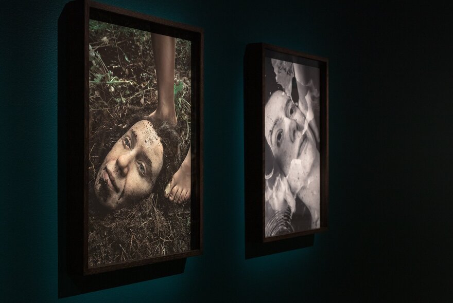 Two artworks on display in a darkened exhibition space.