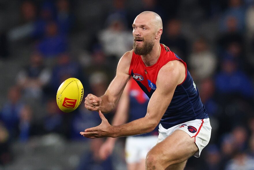 Melbourne skipper Max Gawn handpassing a ball.