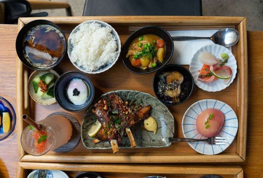 A wooden board filled with Japanese food