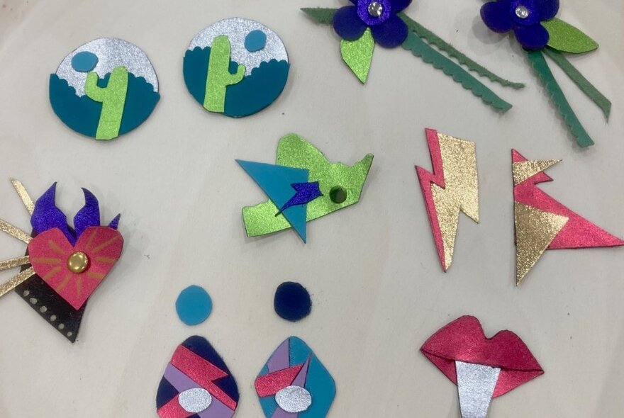 A selection of colourful, repurposed leather accessories such as earings or brooches.