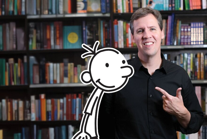Author Jeff Kinney points to his illustrated character Greg Heffley