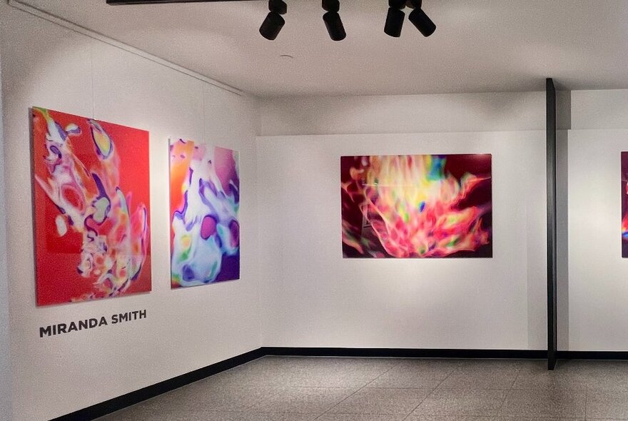 Gallery walls hung with large colourful abstract artworks.