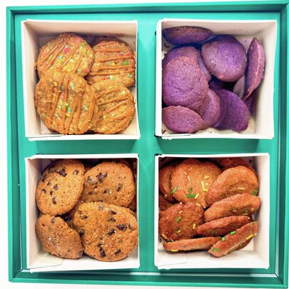 A blue box with different flavoured cookies in each compartment.