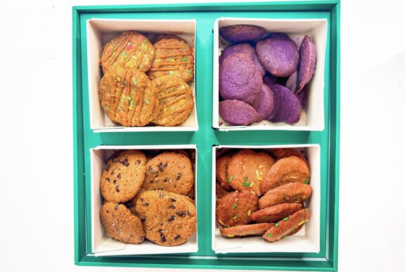 A blue box with different flavoured cookies in each compartment.