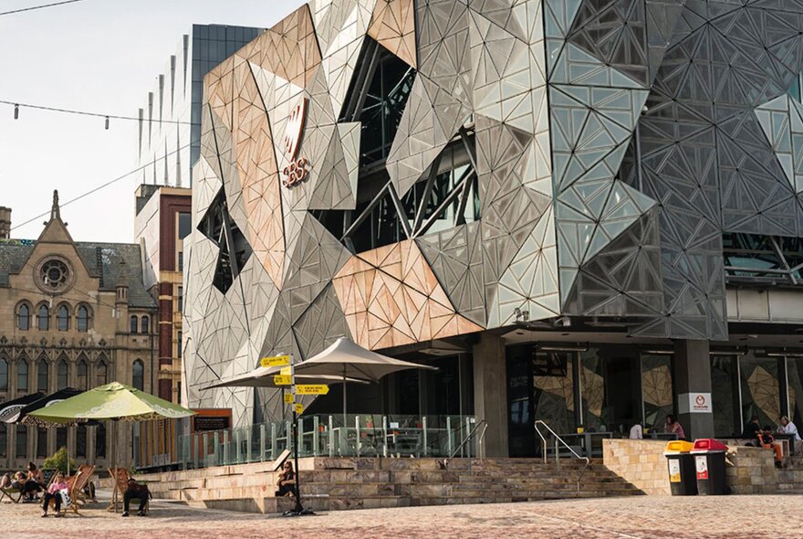 Exterior of a building at Fed Square, showing tessellated facade, with an open piazza area in the foreground.