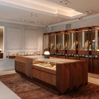 The interior of a jewellery store with glass and timber display cases.