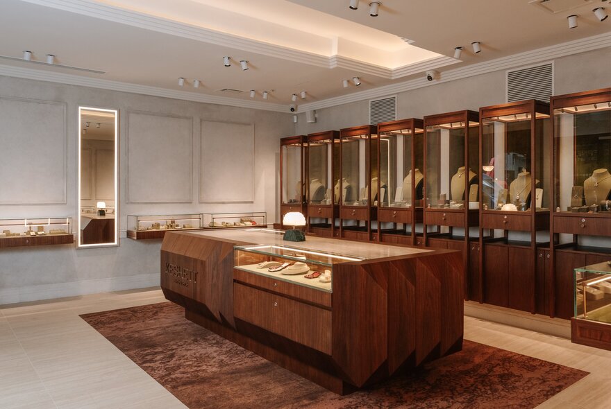 The interior of a jewellery store with glass and timber display cases.
