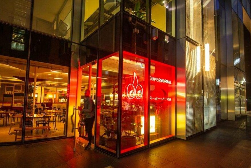 A red neon sign in the window of a restaurant