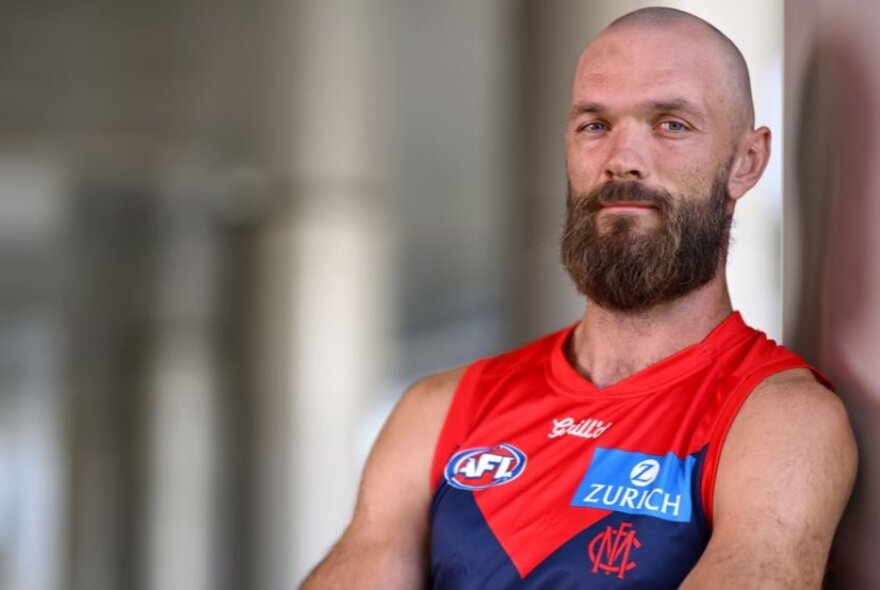 AFL player Max Gawn, wearing Melbourne strip, bald with beard.