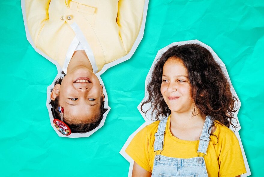 A collage of two children, one upside down, the other right way up, both smiling and looking at each other.