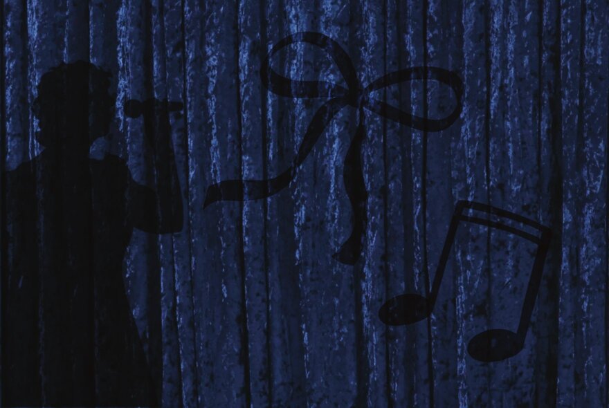 The silhouette of a person singing into a microphone against a dark blue curtain.