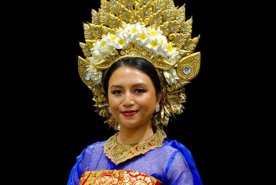 Indonesian dancer wearing an elaborate gold headdress.