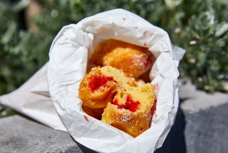 A bag of hot jam donuts
