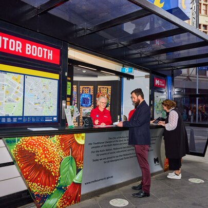 A man getting help from an information stand in Melbourne