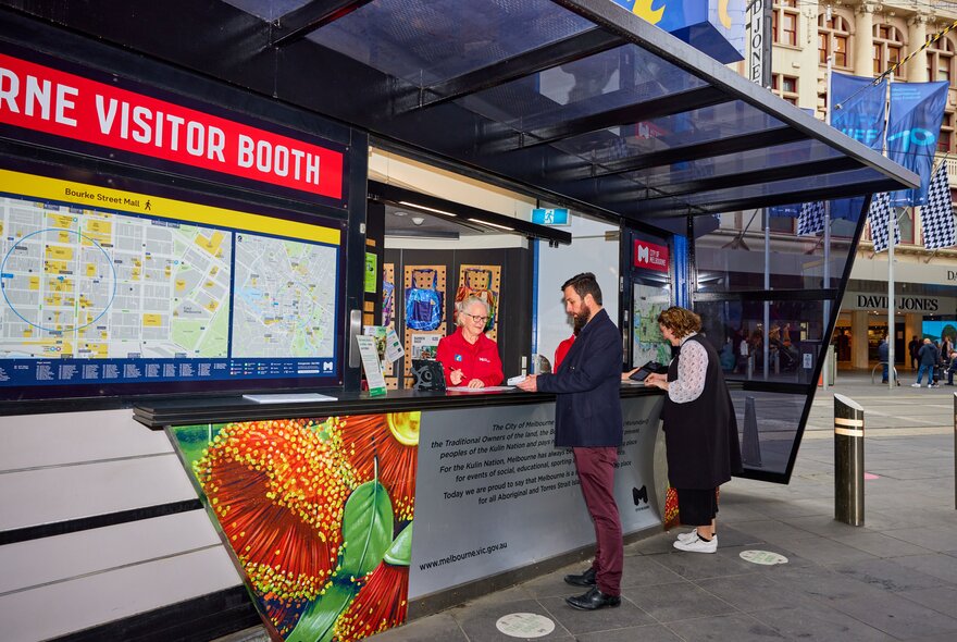 A man getting help from an information stand in Melbourne